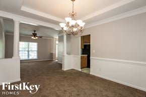 Cornelius house for rent - an empty dining room with a chandelier and a window