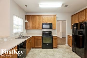 Cornelius house for rent - a kitchen with black appliances and wooden cabinets
