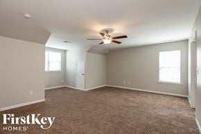 Cornelius house for rent - a bedroom with carpet and a ceiling fan