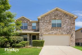 Fort Worth house for rent - A house with a garage and a driveway in front of it.