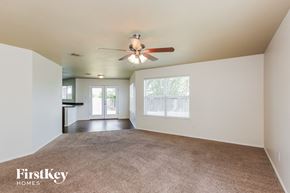 Fort Worth house for rent - A room with a carpet floor and a ceiling fan.