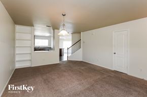 Fort Worth house for rent - A spacious room with a staircase leading to the second floor.