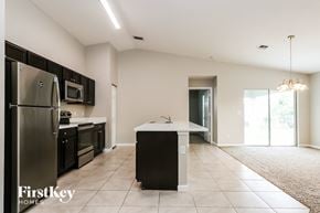 Port St. Lucie house for rent - an empty kitchen with stainless steel appliances and a white counter top