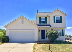 Indianapolis house for rent - A two-story house with a white garage door and green shutters.