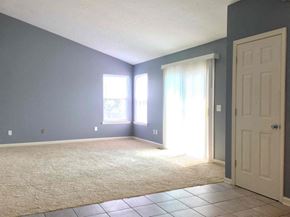 Indianapolis house for rent - A room with a carpeted floor and a white door.