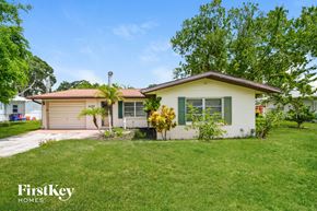 Venice house for rent - A white house with a brown roof and a green lawn in front.