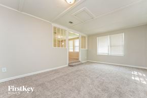 Conyers house for rent - A spacious room with a carpeted floor and a window with blinds.