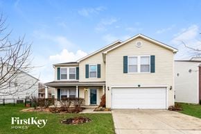 Franklin house for rent - a yellow house with green shutters and a white garage door
