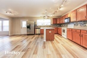 Franklin house for rent - a kitchen with wood flooring and wooden cabinets