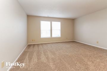 Franklin house for rent - a spacious living room with carpet and a window