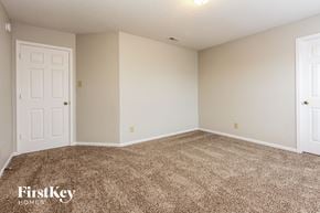 Franklin house for rent - a bedroom with a carpeted floor and a white door