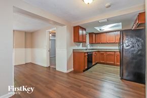 Port Richey house for rent - an empty kitchen with wood flooring and a stainless steel refrigerator