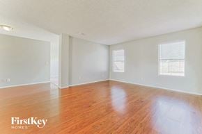 Glendale house for rent - an empty living room with wood floors and white walls
