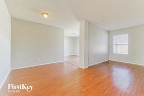 Glendale house for rent - the living room and dining room of an empty house with wood floors