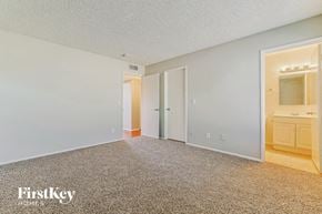 Glendale house for rent - a master bedroom with a carpeted floor and a bathroom