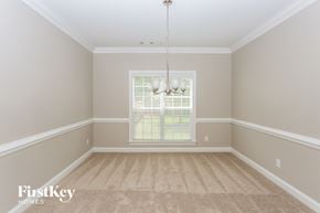 Charlotte house for rent - an empty dining room with carpet and a window