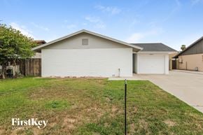 Glendale house for rent - a white house with a yard and a driveway
