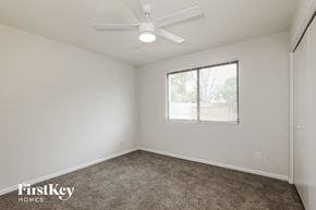 Glendale house for rent - a bedroom with a ceiling fan and a window