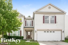 Indianapolis house for rent - a white house with a driveway and a tree