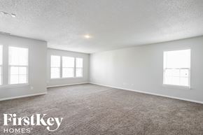 Indianapolis house for rent - the spacious living room with carpeting and three windows
