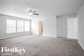 Indianapolis house for rent - a bedroom with carpet and a ceiling fan