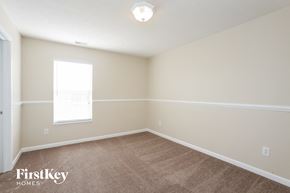 Fishers house for rent - a bedroom with a carpeted floor and a window