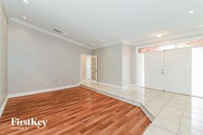 Miami house for rent - the living room and dining room with wood flooring