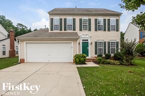 Charlotte house for rent - a white house with green shutters and a white garage door