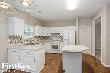 Charlotte house for rent - a white kitchen with white counters and white appliances and white cabinets