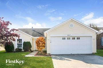 Indianapolis house for rent - the front of a white house with a white garage door