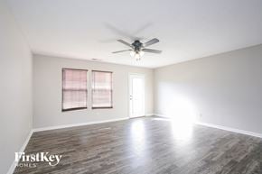 Indianapolis house for rent - the living room of an empty house with a ceiling fan