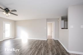 Indianapolis house for rent - an empty living room with wood floors and a ceiling fan