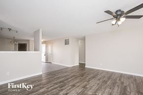 Indianapolis house for rent - the living room and dining room of an empty house with a ceiling fan