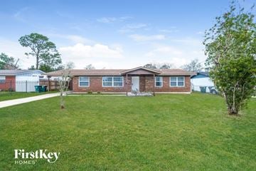 Jacksonville house for rent - a brick house with a yard in front of it