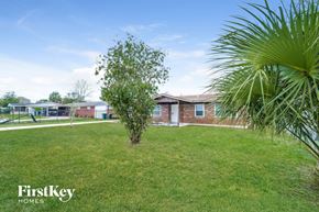Jacksonville house for rent - a house with a yard and a palm tree