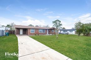 Jacksonville house for rent - a brick house with a yard and a sidewalk