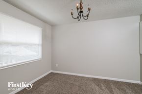Jacksonville house for rent - a bedroom with a large window and a chandelier