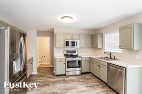 Noblesville house for rent - A kitchen with a refrigerator, sink, and stove.