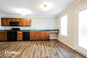 Camby house for rent - A kitchen with wooden floors and a FirstKey Homes logo.