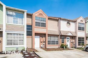 Orlando house for rent - a group of three story apartment buildings with a sidewalk in front of them