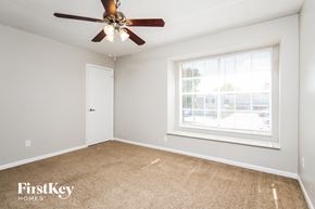 Orlando house for rent - a bedroom with a ceiling fan and a window