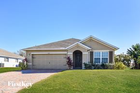 Cape Coral house for rent - a house with a lawn and a blue sky
