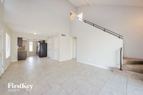 Peoria house for rent - A spacious living room with a staircase on the right side.