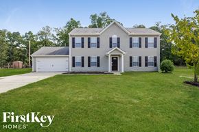 Wingate house for rent - a white house with black shutters and a lawn
