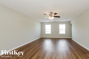 Wingate house for rent - a spacious living room with hardwood floors and a ceiling fan