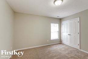 Wingate house for rent - a bedroom with a white door and a carpeted floor