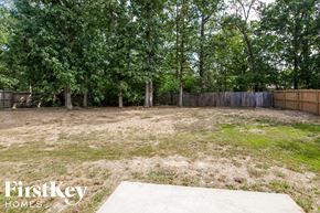 Wingate house for rent - the backyard has a lot of grass and trees
