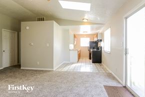 Indianapolis house for rent - an empty living room with a kitchen in the background
