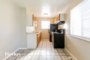Indianapolis house for rent - a small kitchen with a stove and a refrigerator