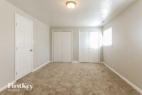 Indianapolis house for rent - a bedroom with two closets and a carpeted floor
